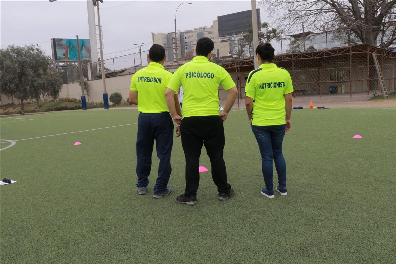 Entrenador, psicólogo y nutricionista de Soccer Lima FC en 2017, de espaldas, mirando la cancha