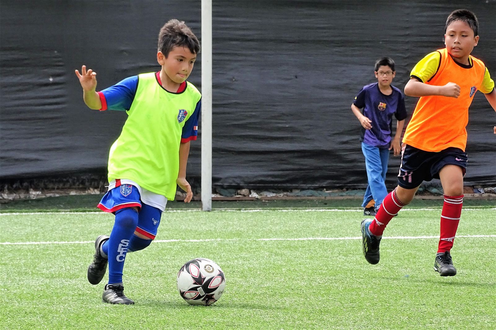 Alumnos de Soccer Lima FC disputando el balón en un partido de práctica